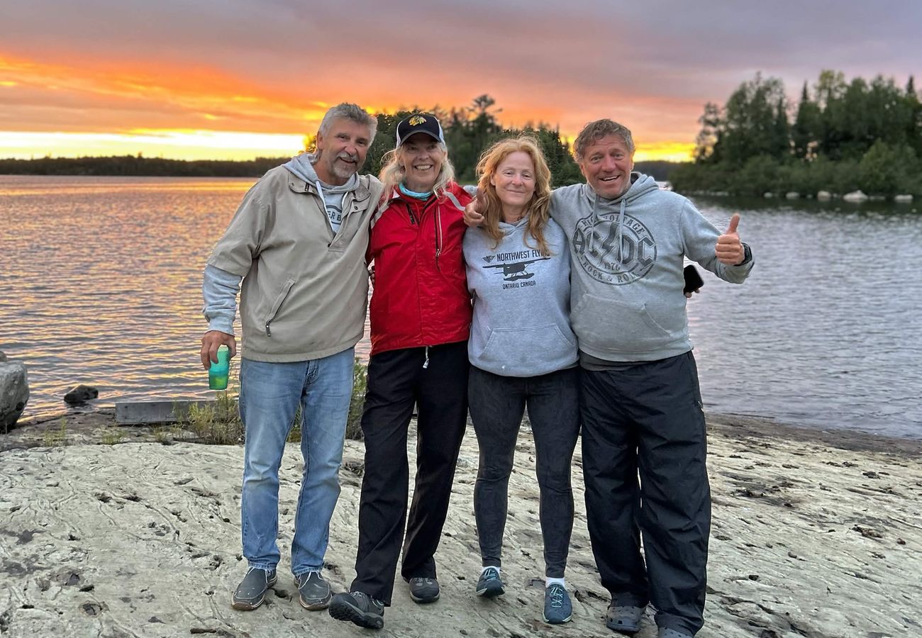 Guests gathered on the beach at sunset